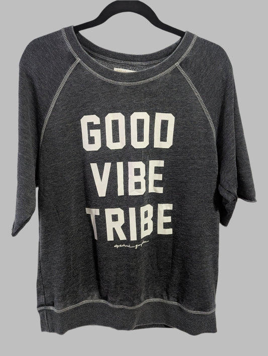 Front view of a grey Spiritual Gangster crew neck sweatshirt with Good Vibe Tribe text hanging on a hanger.
