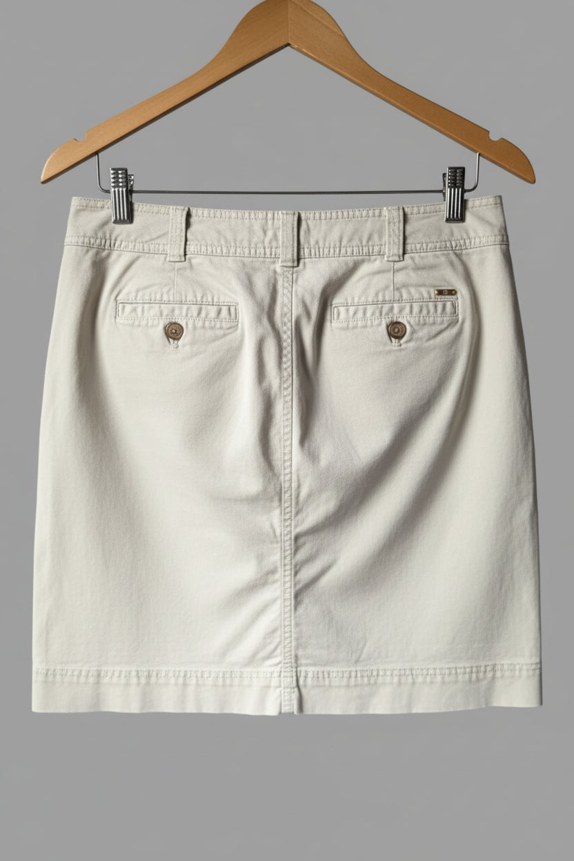 Back view of the khaki beige Tommy Hilfiger midi skirt, showcasing the clean tailored fit, back pockets, and classic belt loops.