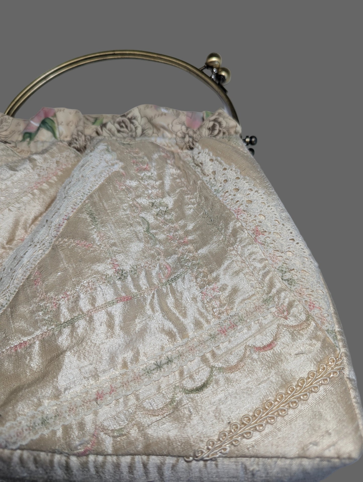 Vintage pastel brocade frame purse with a romantic scenic tapestry pattern and gold-tone metal kiss-lock handle.