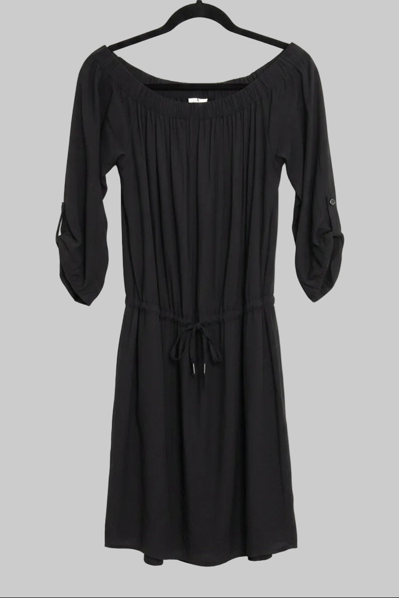 Front view of a black Lole Jamie off-the-shoulder midi dress with a tie waist hanging on a hanger against a gray background.