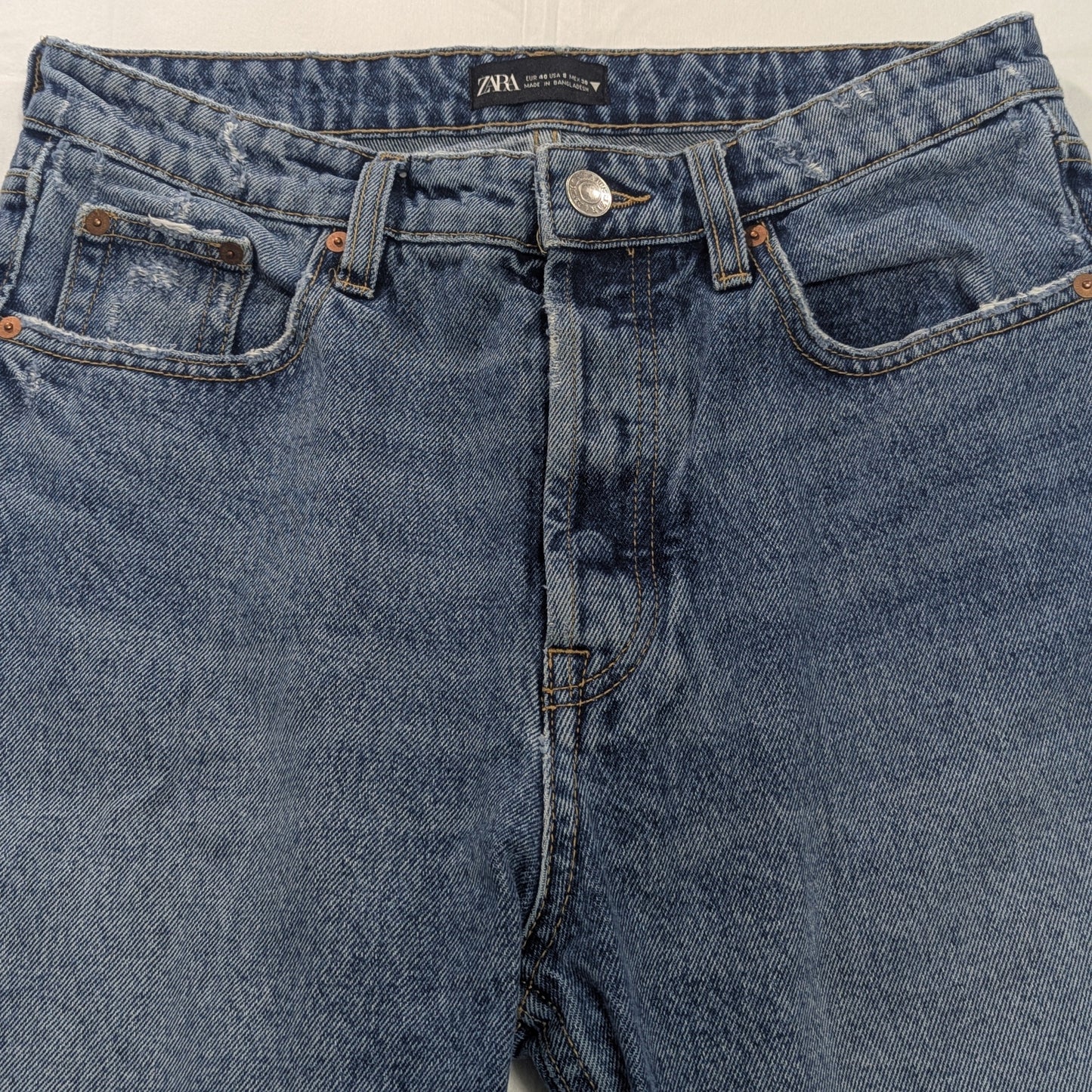 Internal view of the Zara denim collection waistband label and button closure, showing women's size 8.