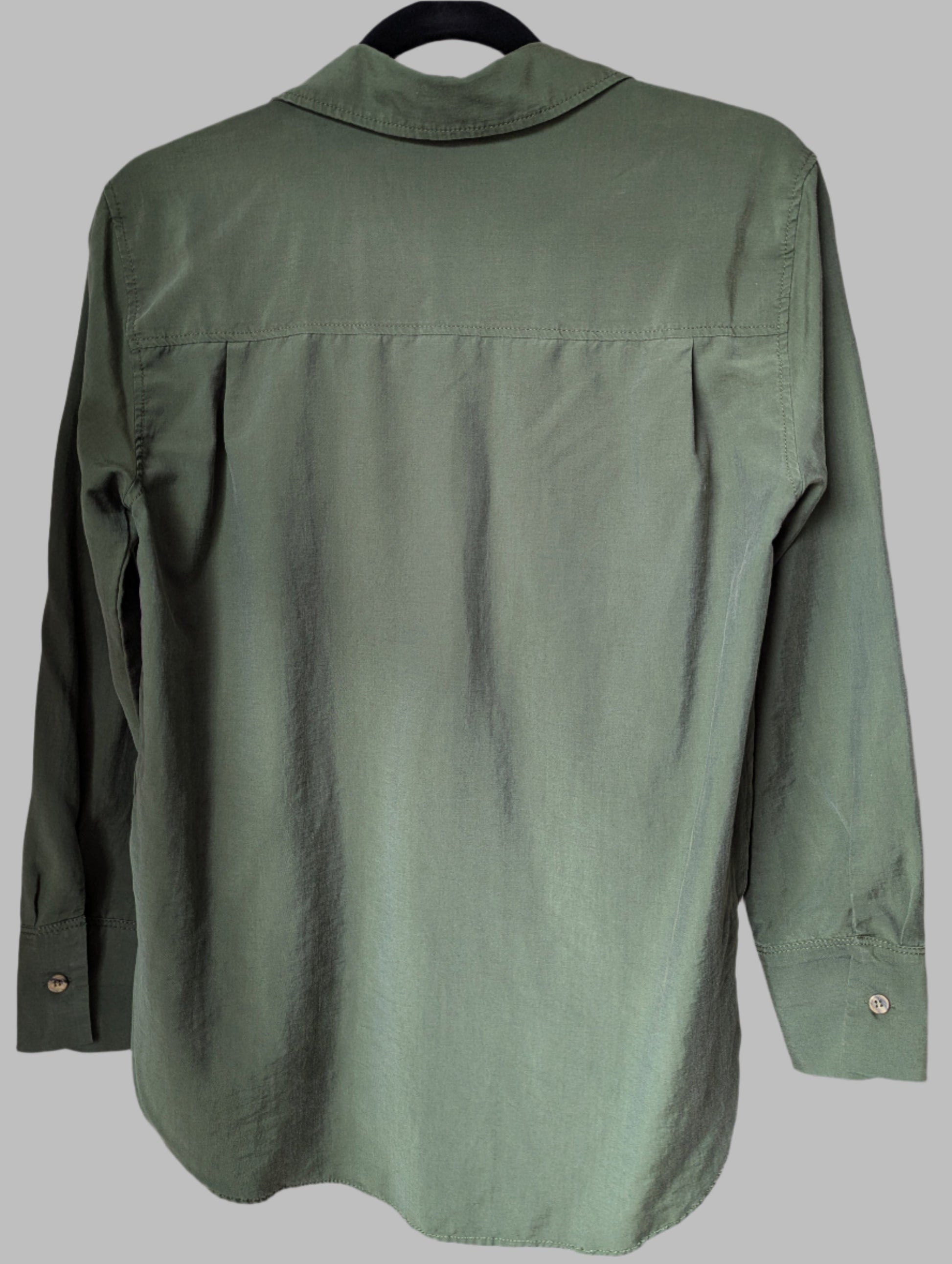Rear view of a lightweight green Zara button-up shirt, showing the fluid drape of the lyocell fabric